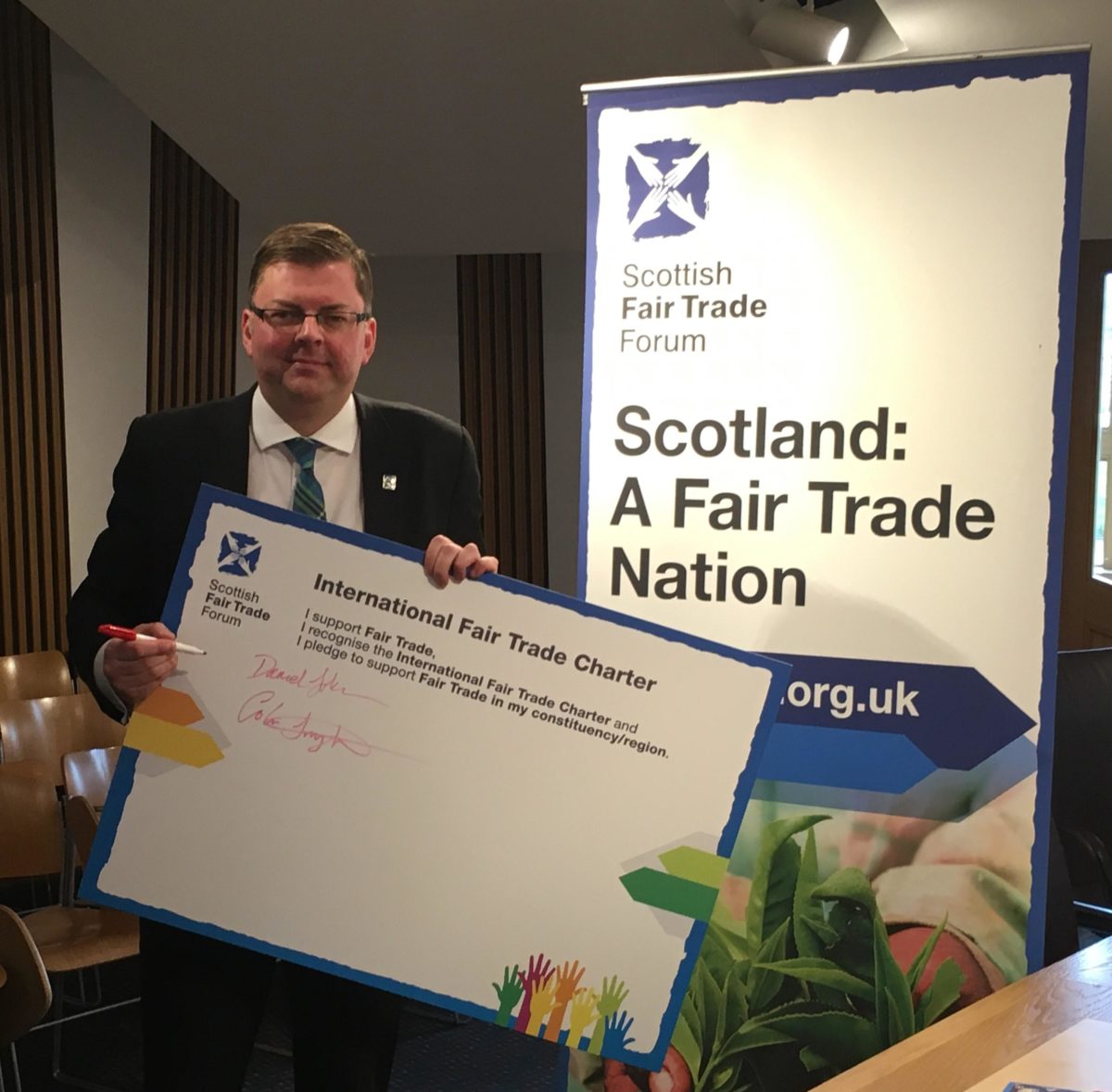 Colin Smyth MSP signing the International Fairtrade Charter